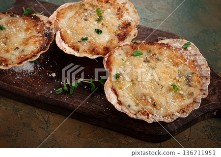scallop shells, stuffed, baked with cheese, in the oven, julienne with scallops, 136711951