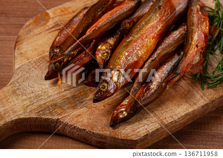 cold smoked capelin, on a wooden chopping board, no people, 136711958