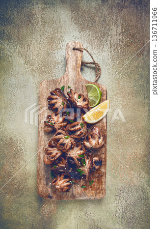 grilled baby octopus,with green onions, with lemon wedges, on a wooden chopping board, homemade, no people, grilled baby octopus,with green onions, with lemon wedges, on a wooden chopping board, homemade, no people, 136711966