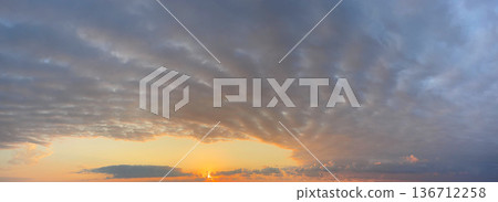 Stratus clouds on sunset sky Stratus clouds on sunset sky 136712258