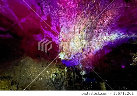 Crystalline cave with shimmering, multicolored stalactites and stalagmites Crystalline cave with shimmering, multicolored stalactites and stalagmites 136712261
