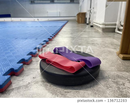 elastic resistance bands on the weight in fitness hall elastic resistance bands on the weight in fitness hall 136712283