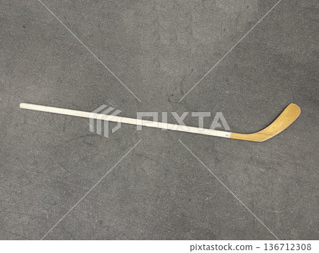 hockey stick isolated on gray floor hockey stick isolated on gray floor 136712308
