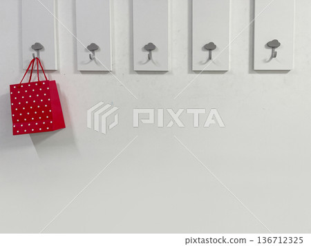 a gift bag is hanging on a hook on the left a gift bag is hanging on a hook on the left 136712325