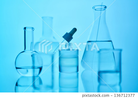 Scientific laboratory glassware filled with blue liquid Scientific laboratory glassware filled with blue liquid 136712377