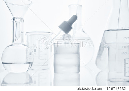 Chemical liquid dropping from dropper into cosmetic bottle 136712382