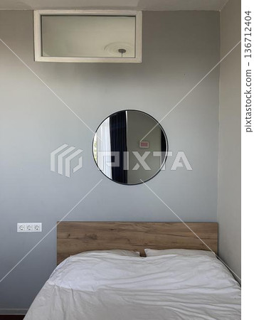 cozy bedroom with mirror and bed 136712404