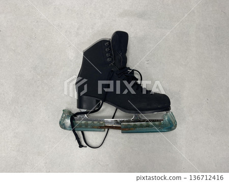 an ice skate on the floor in the locker room an ice skate on the floor in the locker room 136712416