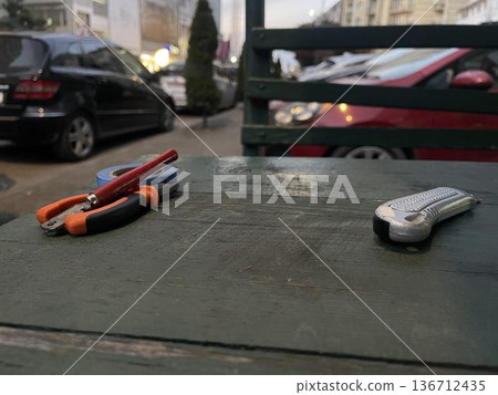 a construction knife on the right side of the table 136712435