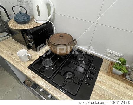the stove in the kitchen near the microvawe 136712438