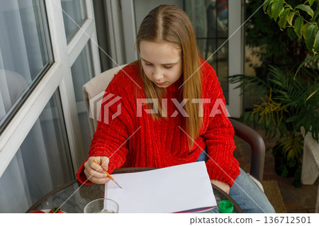 Serious kid drawing. Cute child at home Serious kid drawing. Cute child at home 136712501