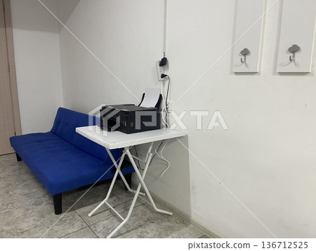 a printer on the table near the couch a printer on the table near the couch 136712525