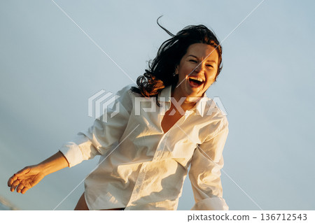 Joyful Laughter Captured in Gentle Breeze Moment 136712543