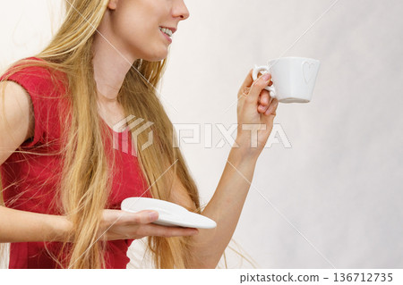 Blonde girl with coffee cup Blonde girl with coffee cup 136712735