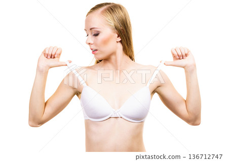 Young woman holding bra strap Young woman holding bra strap 136712747