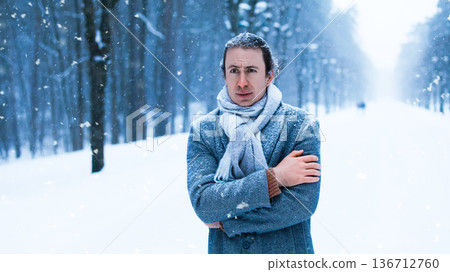 Frozen man hugging himself in a snowy park during a blizzard. He looks sad and cold, covered in snow, representing winter depression and severe frost. High quality photo Frozen man hugging himself in a snowy park during a blizzard. He looks sad and cold, covered in snow, representing winter depression and severe frost. High quality photo 136712760
