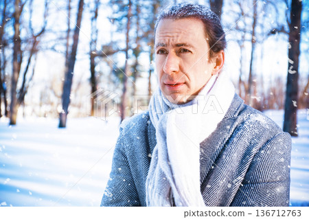 A portrait of a frozen man standing in a snowy park. He appears frozen and pensive, with snow in his hair, during a sunny snowstorm. Conceptually, it suggests worsening weather and frost. High quality A portrait of a frozen man standing in a snowy park. He appears frozen and pensive, with snow in his hair, during a sunny snowstorm. Conceptually, it suggests worsening weather and frost. High quality 136712763