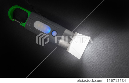 hand flashlight close-up, on a black 136713384