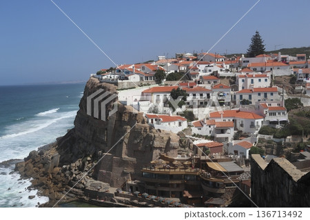 Traditional white village of Azenhas do Mar perched on a cliff, Portugal. 136713492