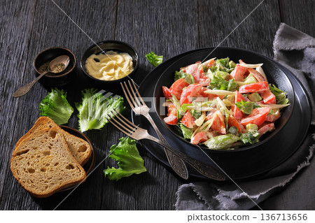 Avocado tomato salad with lettuce and mayonnaise 136713656