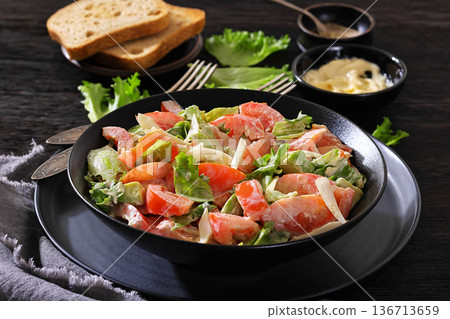 Avocado tomato salad with lettuce and mayonnaise 136713659