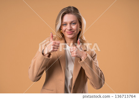 Positive Businesswoman With Hand Sign Likes, Thumbs Up Gesture. Lady on Beige 136713764