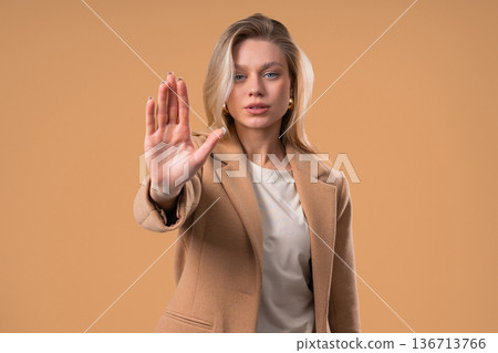 Blonde Businesswoman With Palm In Stop Gesture, Clear Assertive Body Language Blonde Businesswoman With Palm In Stop Gesture, Clear Assertive Body Language 136713766