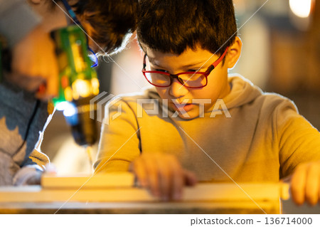 Young boy learning woodworking skills with adult Young boy learning woodworking skills with adult 136714000