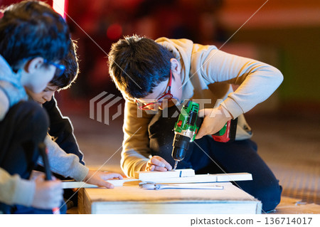 Children learning carpentry skills using power tools Children learning carpentry skills using power tools 136714017