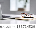 Productive Office Workspace With Laptop, Glasses, Notebook and Pen on Clean White Desk 136714529