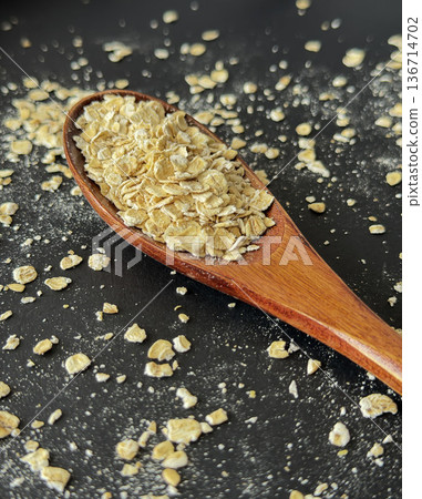 Quick Oats on Wooden Spoon Dark Food Background 136714702