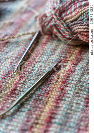Cozy Handmade Knitting Scene with Colorful Wool Yarn Balls and Wooden Needles 136714823