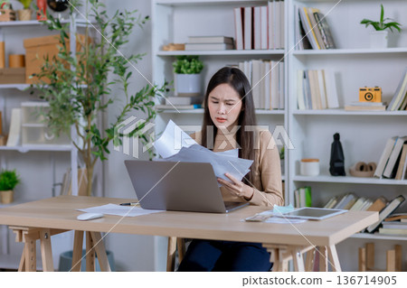 Businesswoman angry throwing papers over the herself in office  136714905