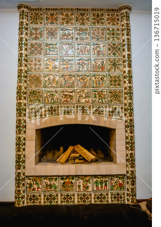 Decorative tiled fireplace in traditional rustic interior Decorative tiled fireplace in traditional rustic interior 136715019