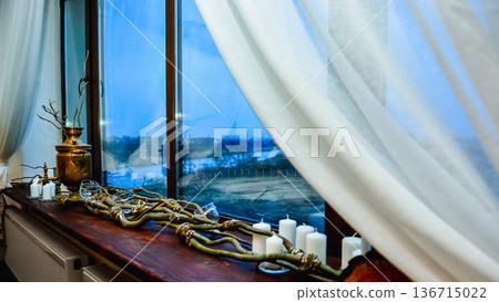 Windowsill decorated with samovar candles and white curtains 136715022