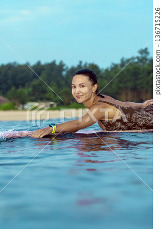 Energetic Woman With Bright Smile Engaged In Coastal Surfing Adventure 136715226