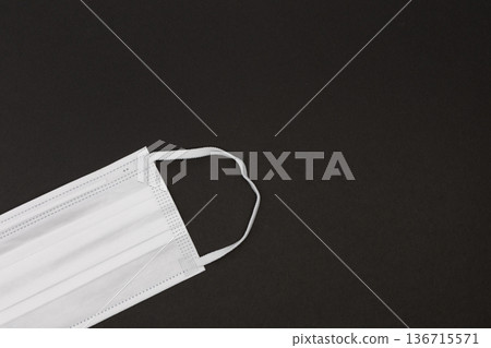 Nonwoven mask placed on a black background Image of hygiene management and infection prevention Nonwoven mask placed on a black background Image of hygiene management and infection prevention 136715571