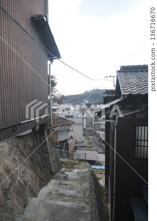 An alleyway view of an old residential area seen from halfway up the hill 136716670