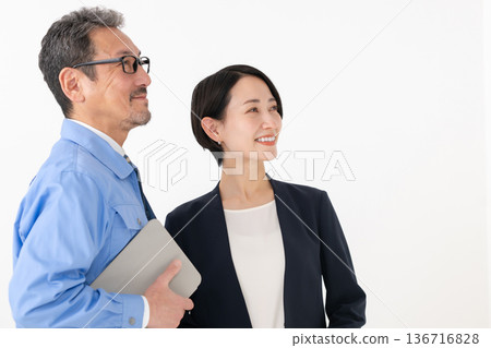 A man and a businesswoman wearing work clothes 136716828