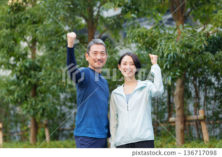 Men and women exercising 136717098