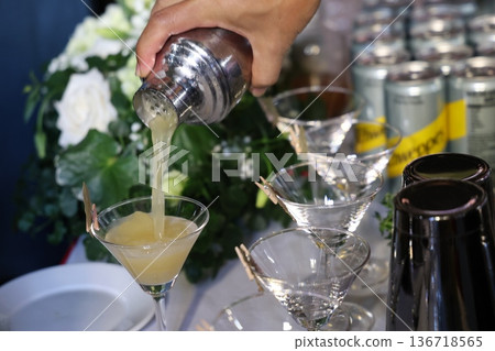Hand holding a cocktail glass Hand holding a cocktail glass 136718565
