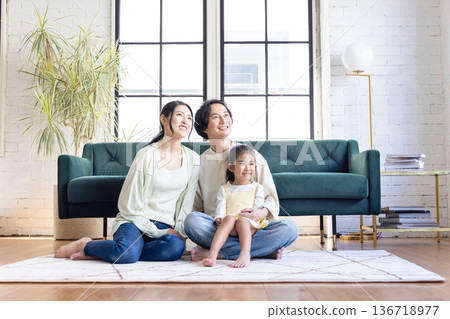 A young family relaxing in the living room A young family relaxing in the living room 136718977