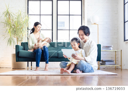 A family relaxing in the living room A family relaxing in the living room 136719033