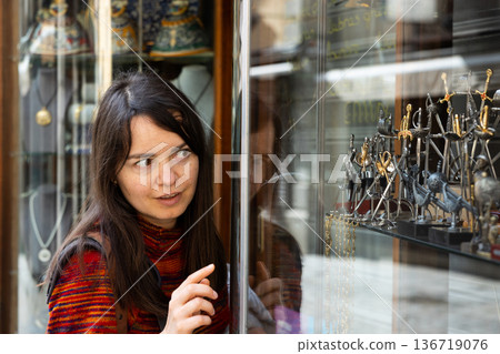 Woman tourist choosing handmade souvenirs Woman tourist choosing handmade souvenirs 136719076