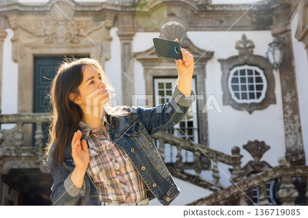 Female tourist having video call while standing at Mateus Palace 136719085