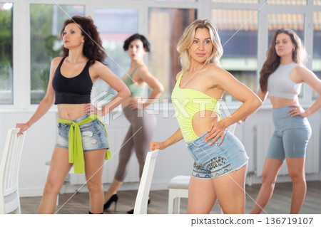 Blonde performing sensual burlesque choreography with chair at dance class 136719107