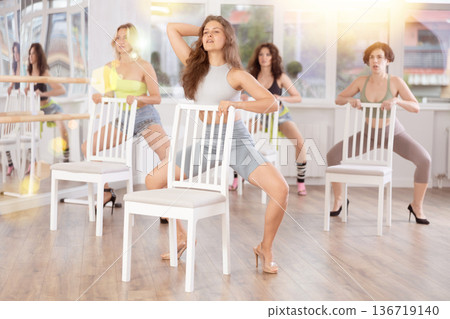 Young woman in high heels partaking in exotic chair dance class 136719140