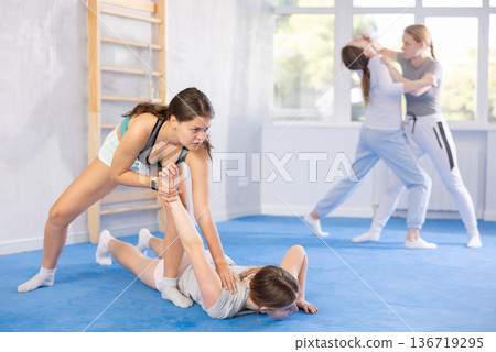 Pair self defense training - two teenage girls doing power grabs Pair self defense training - two teenage girls doing power grabs 136719295