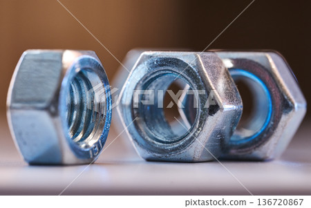 Detailed close up of chrome plated internal thread fasteners with shallow depth of field 136720867