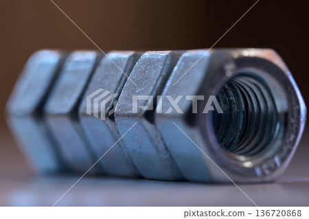 Detailed close up of chrome plated internal thread fasteners with shallow depth of field 136720868